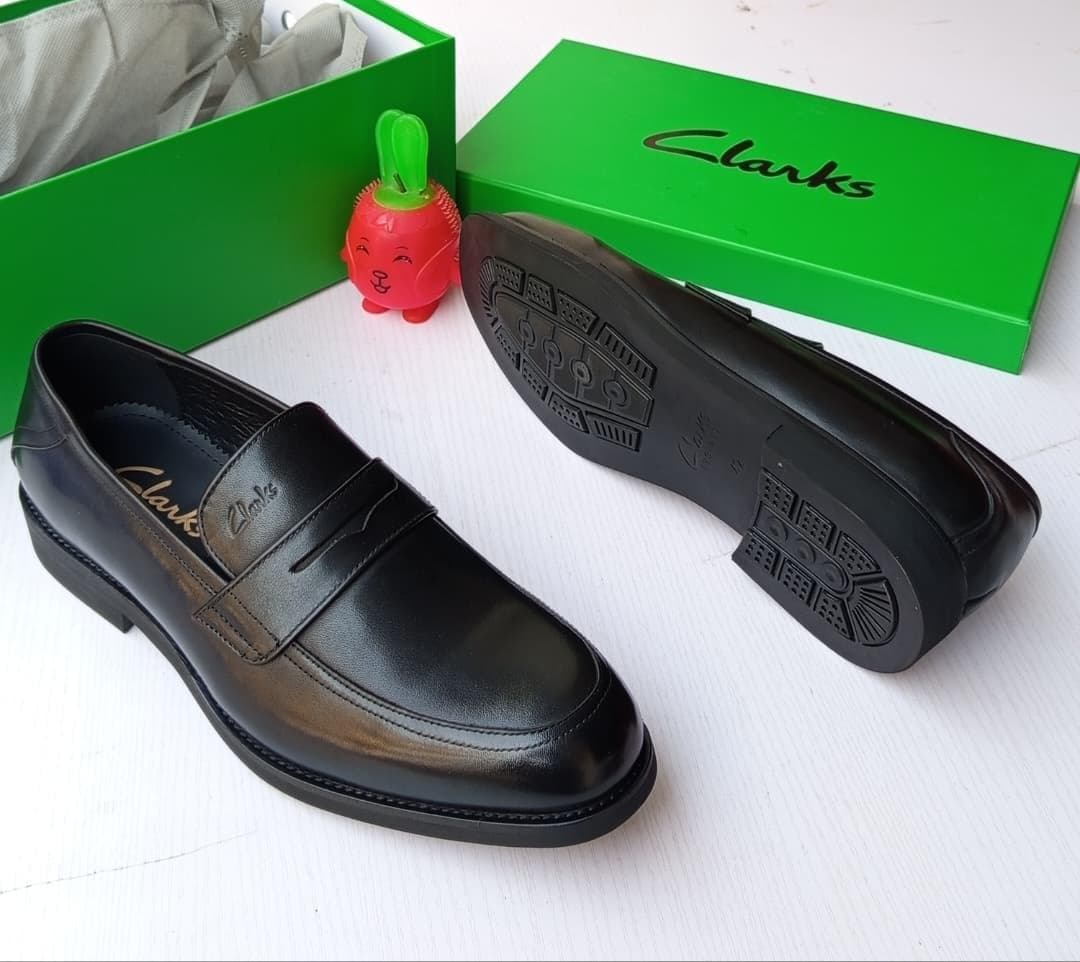 > Clarks Black Classic Loafers shoe.